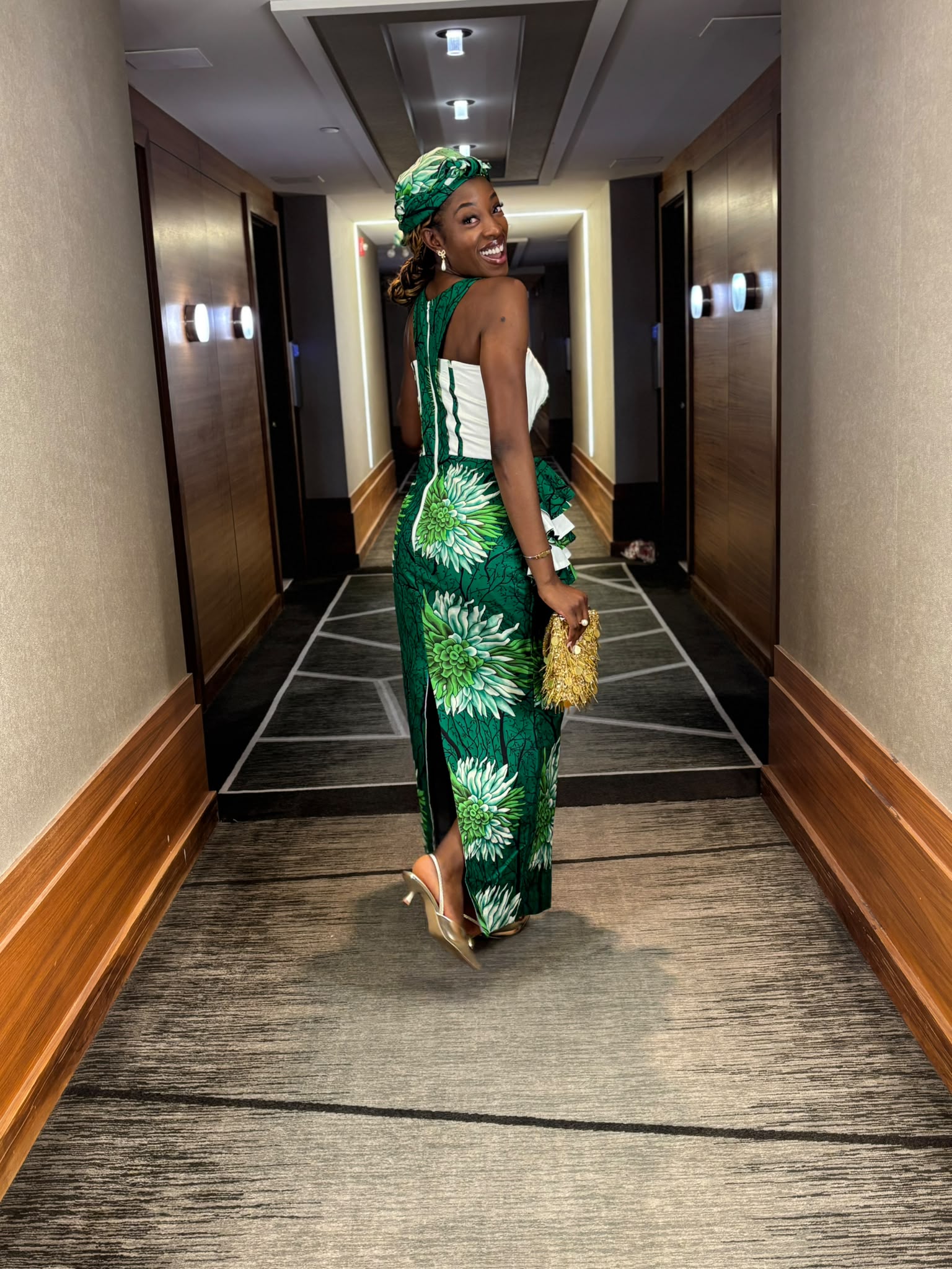 Emerald Blossom (Rear Silhouette) — Back view of the green floral Ankara gown